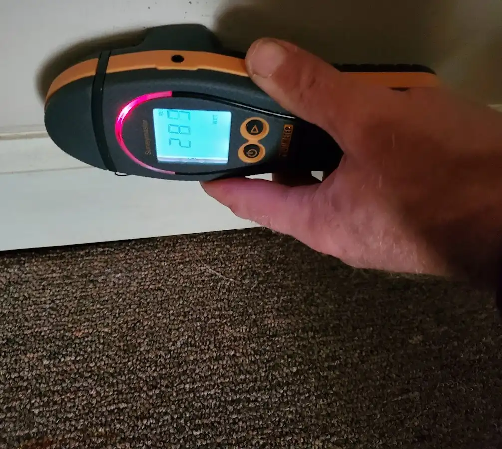 Moisture detection at baseboard during Storm Damage Restoration in Oelwein